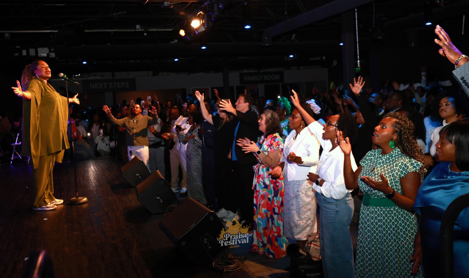 People responding to an altar call at an Angaza worship event