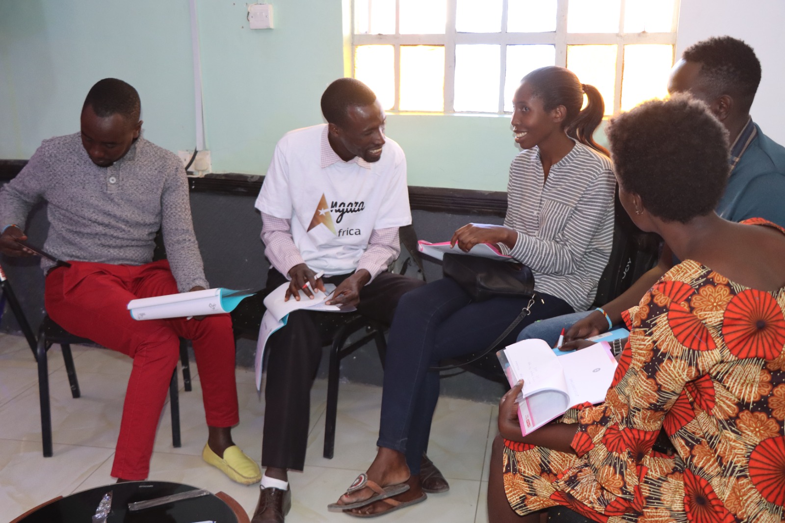 Mentor working with youth entrepreneurship participants in Rwanda